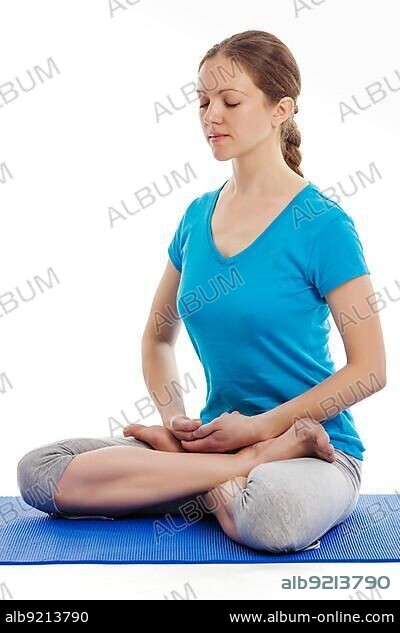 Yoga, young beautiful woman yoga instructor doing Lotus Position (padmasana with bhairava mudra) asana exercise, cross-legged sitting asana for meditation, isolated on white background.