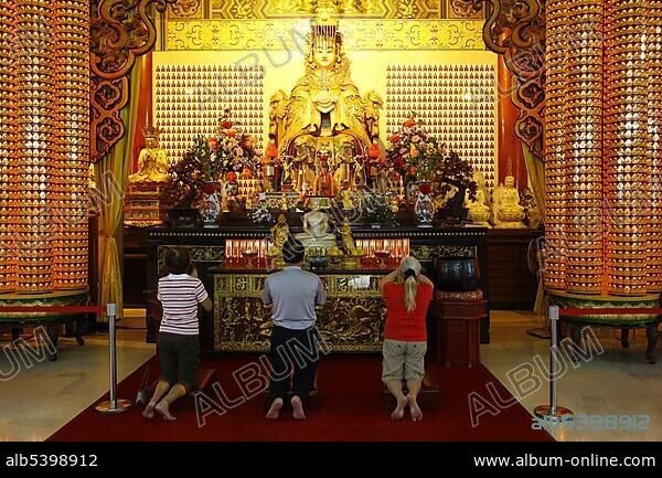 Praying people in front of the statue of Mazu, tutelary goddess, Chinese Thean Hou Temple, Kuala Lumpur, Malaysia, Asia.