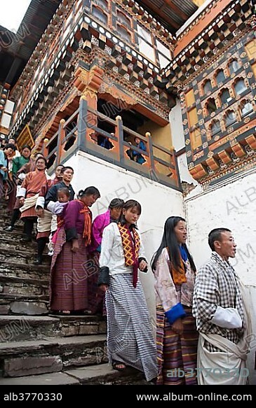 Tibetan Buddhist festival, people wearing the traditional Gho robe standing on a staircase in a queue, Rinpung Dzong Monastery and Fortress, courtyard, Paro, Himalayas, Bhutan, South Asia, Asia.