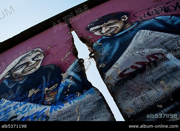 Original Berlin Wall with graffiti in the East Side Gallery, held together by a bicycle lock, Berlin, Germany, Europe.