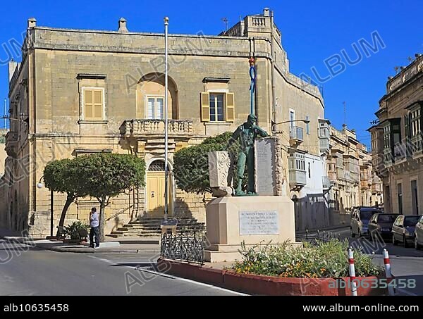 Historic streets in Tarxien area, near Valletta, Malta small square with war memorial sculpture.