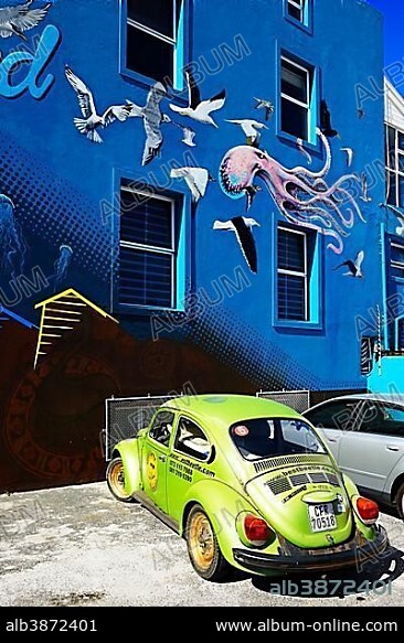Green VW Beetle in front of painted house facade, Muizenberg, Cape Town, Western Cape, South Africa, Africa.