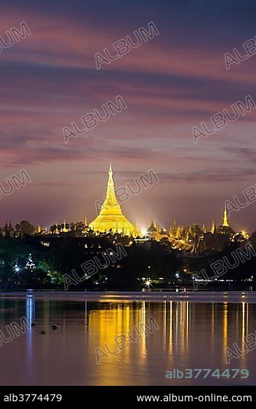 Illuminated Shwedagon Pagoda at sunset, The Great Dagon Pagoda, seen from Kandawgyi Lake, Yangon, Myanmar, Asia.