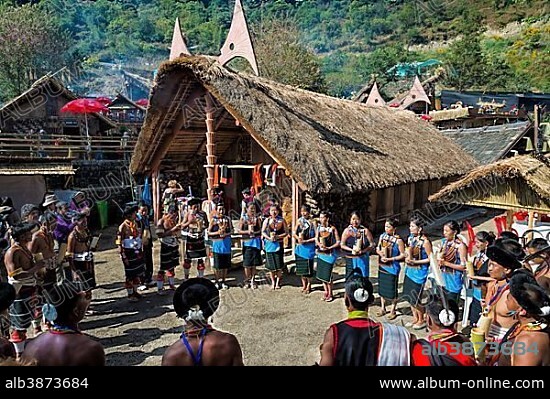 Naga tribes people in front of a traditional house, Kisima Nagaland Hornbill festival, Kohima, Nagaland, India, Asia.