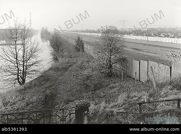 View over the Berlin Wall in 1985, panorama of the inner German border, known as the Death Strip, canal and fields in the autumn mist, Berlin, Germany, Europe.