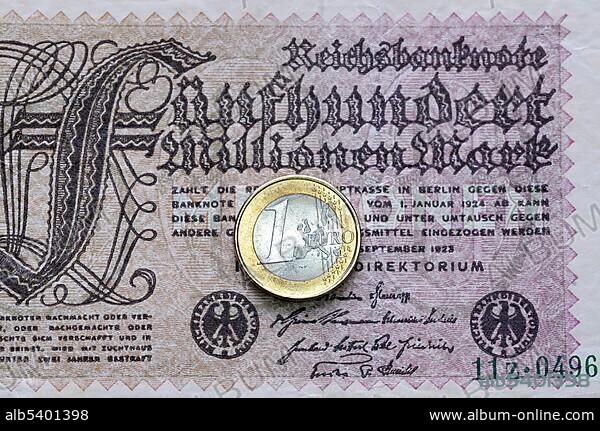 Old 500 Million Mark banknote and a one Euro coin, symbol for inflation.