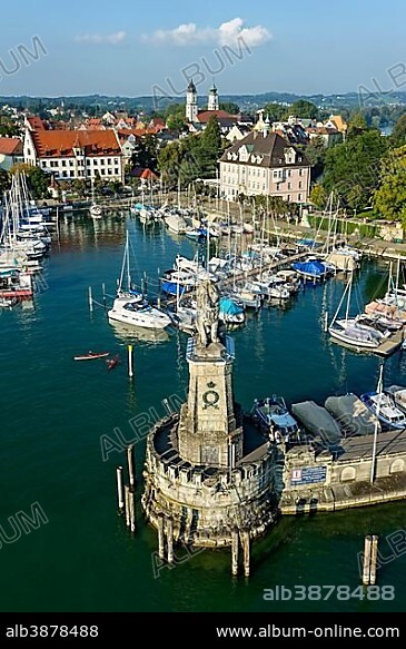Bavarian Lion at the port, Notre-Dame Cathedral behind, St. Stephen's Church on the island, Lake Constance, Lindau, Swabia, Bavaria, Germany, Europe.