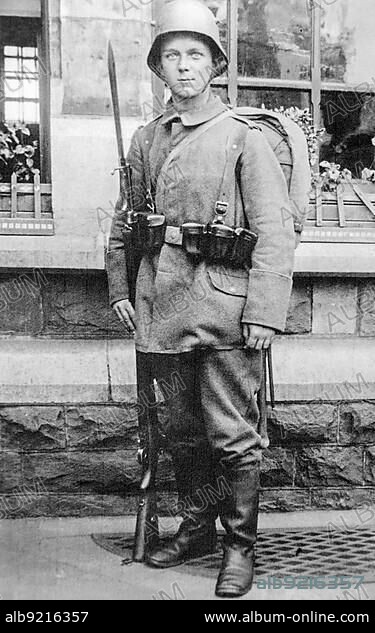 Young German WWI Bavarian infantry soldier, infantryman posing in battledress with rifle, bayonet and stahlhelm in 1917 during First World War One.