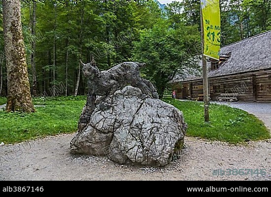 Lynx sculpture, forest and trail at the Pilgrimage church of St. Bartholomew, Lake Koenigssee, Berchtesgaden, Berchtesgadener Land, Bavaria, Germany, Europe.
