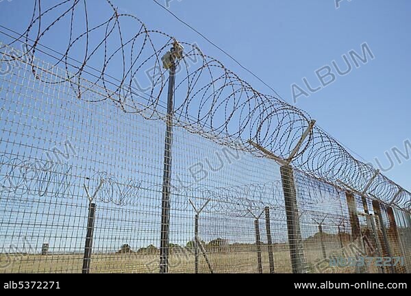 Barbed wire fence around the formerly prison on Robben Island, Cape Town, South Africa, Africa.