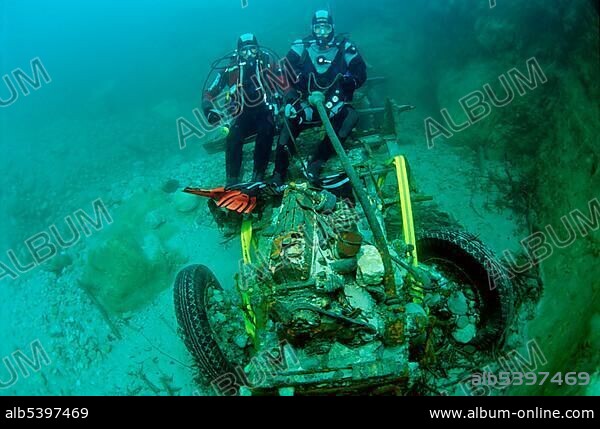 Two scuba divers on a sunken truck from the 2nd World War in the river Enns, Upper Austria, Austria, Europe.