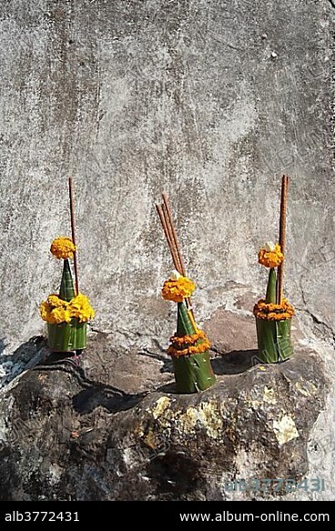 Theravada Buddhism, religious offerings at a wall, That Chomsi on Mount Phu Si, Luang Prabang province, Laos, Southeast Asia, Asia.