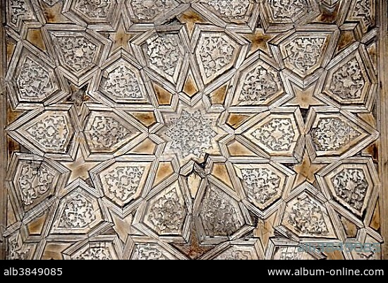 Geometric wood carving at the entrance gate to Madrasah Kukeldash Bukhara Uzbekistan.