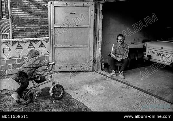 Germany, Greppin, 31 March 1992, village between Wolfen and Bitterfeld, man in his garage, child, Trabant, Europe.