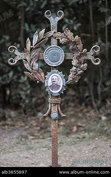 Iron cross on a grave with a sprig of laurel, oak leaves and a portrait medallion, World War I in 1917, Aquileia, Udine province, Friuli-Venezia Giulia, Italy, Europe.