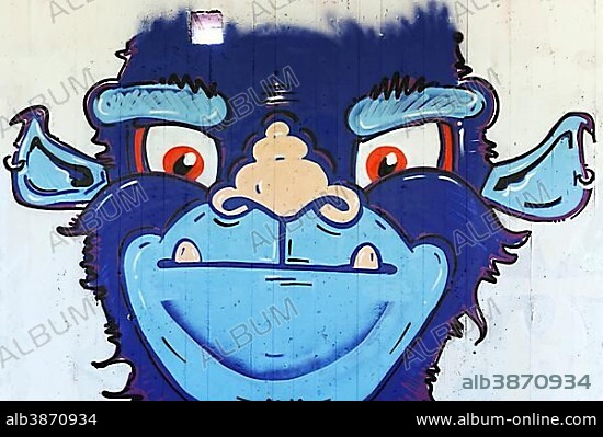 Blue monster with a funny monkey face, graffiti, street art, Düsseldorf, North Rhine-Westphalia, Germany, Europe.
