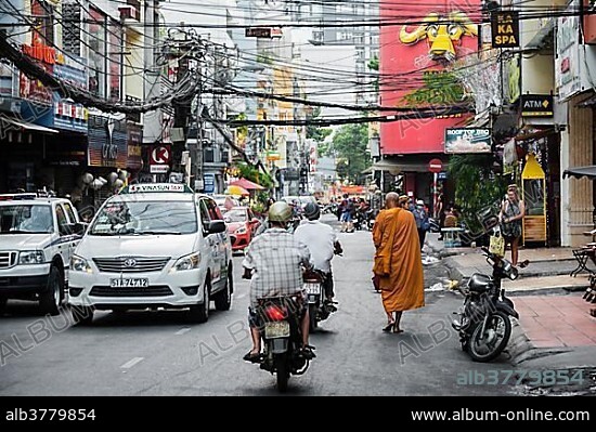 Buddhist monk walking, road, Ho Chi Minh City, Ho Chi Minh City, Vietnam, Asia.