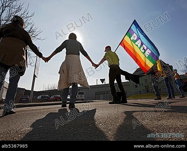 Human chain with peace flag protesting against nuclear power in front of the Neckarwestheim nuclear plant in Stuttgart, Baden-Wuerttemberg, Germany, Europe.