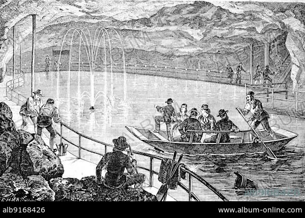Berchtesgaden Salt Mine is the oldest active salt mine in Germany, Bavaria, here the lake in the cave, visitors in a boat in the mine, 1880, Historic, digitally restored reproduction of an original 19th century artwork, exact original date unknown.