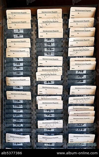 Board with time-stamped cards, time-punch machine, former Dujardin distillery, Krefeld-Uerdingen, North Rhine-Westphalia, Germany, Europe.