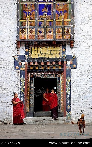 Monks of the Drukpa monastic community entering the courtyard of Trashigang Dzong fortress, Trashigang, Trashigang district, Bhutan, Asia.