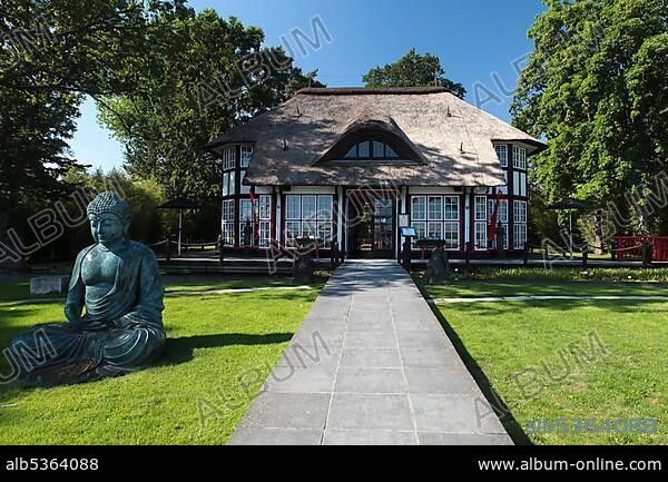 Thatched roof house Mikado Garden with Buddha rope, Timmendorfer Strand, Ostholstein, Schleswig-Holstein, Germany, Europe.