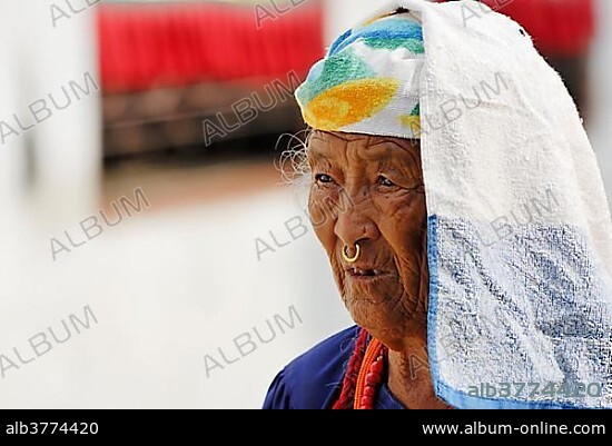 Old woman walking around stupa of Boudhanath, Kathmandu, Nepal, Asia.