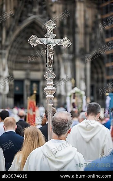 Corpus Christi, clergy hold a cross at a mass in front of Cologne Cathedral, Cologne, North Rhine-Westphalia, Germany, Europe.