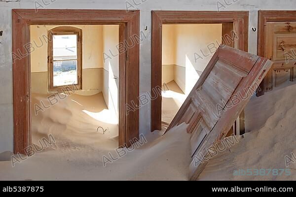 Interior of house ruins filled with sand in Kolmanskop, Namibia, Africa.