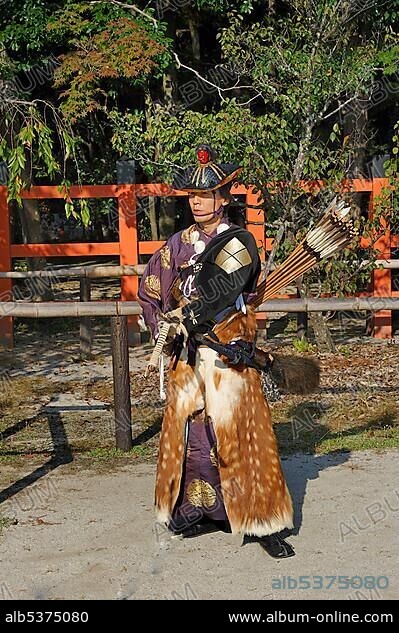 Archer with bow and arrow, dressed in armour of the Heian period, during a ritual Shinto equestrian competition, Kamigamo Shrine, Kyoto, Japan, Asia.