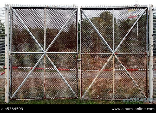 Gate of the border fence, expanded metal fence, border signal fence, barbed wire fence with gate in the village republic of Rüterberg, Elbe cycle path, column path, perforated plate path, inner-German border installation, Green Belt, border path, UNESCO Biosphere Reserve River Landscape.
