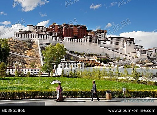People walking by Potala Palace Lhasa Tibet China.