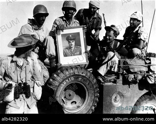 Israeli soldiers bringing back a portrait of Nasser as a souvenir. 1956. Egypt - Suez Crisis. Washington - National Archives.