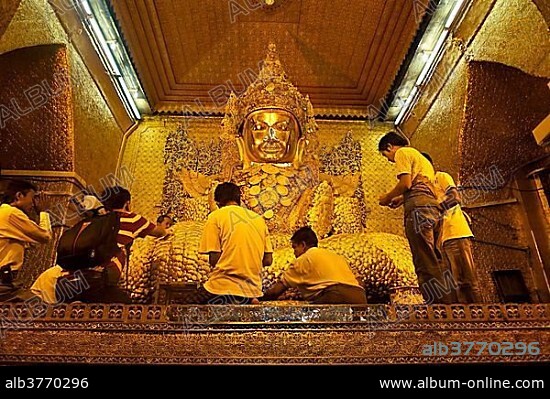 The most holy Buddha of the country, the golden Mahamuni Buddha is covered in gold leaf by believers, Mandalay, Burma, Myanmar, Southeast Asia, Asia.