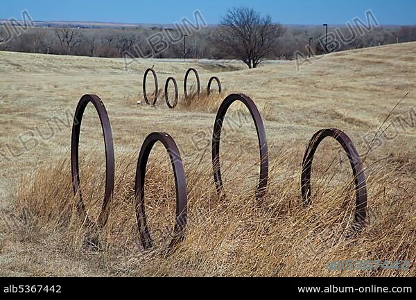 Wagon wheel sculptures and original wagon wheel trail ruts mark the Oregon Trail, where thousands of pioneers traveled west between 1840 and 1869, Sutherland, Nebraska, USA, North America.