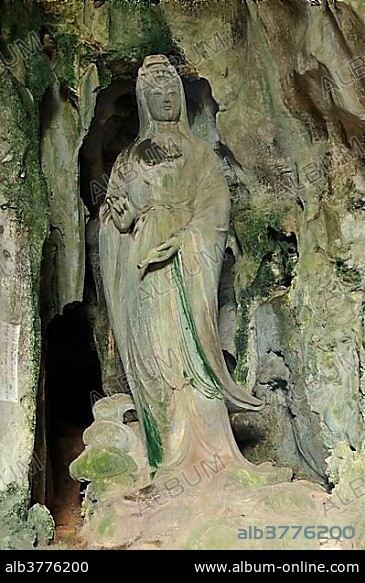Hoa Nghiem cave with statue of Quan Am, holding a fap lam bottle with wonder-working water in the left hand, Marble Mountains or Ngu Hanh Son, Thuy Son, Da Nang, Vietnam, Asia.