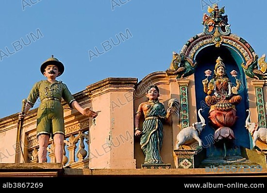 Indian Goddess Lakshmi flanked by elephants and British soldier in Uniform with a rifle, sculptural decoration on an old house, Karaikudi, Chettinad, Tamil Nadu, South India, India, Asia.