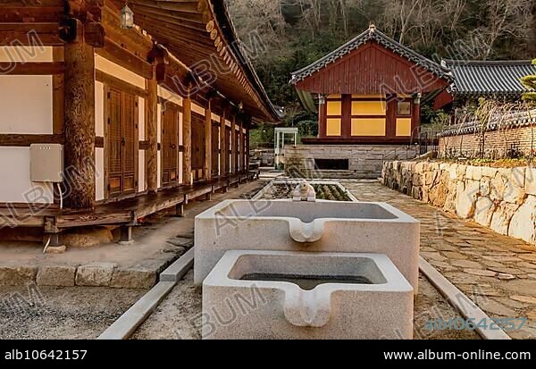 Concrete water cistern with turtle fountain at Buddhist temple.