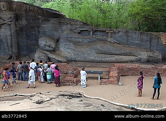 Tourists, Reclining Buddha, Gal Vihara, Sacred City, Polonnaruwa, North Central Province, Sri Lanka, Asia.