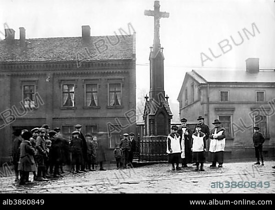 Village square with priest and altar boy ca. 1930, exact place unknown, Germany, Europe.