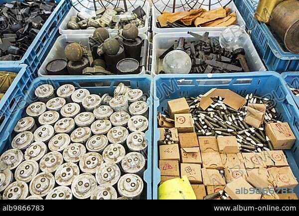 Stand at militaria fair selling World War Two memorabilia like bomb fuzes, M67 fragmentation grenades, bullets, ammunition and WW2 anti-tank No. 74 sticky bombs.