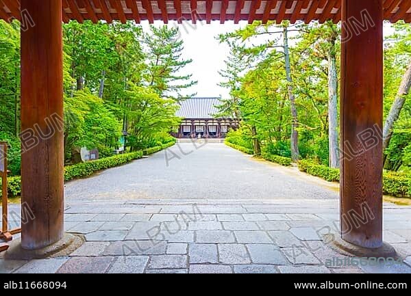 Looking from sidewalk, through entrance down main path to the Classical Golden Hall, Kondo, a national treasure, of the Toshodai-ji Buddhist temple in Nara, Japan. Horizontal.