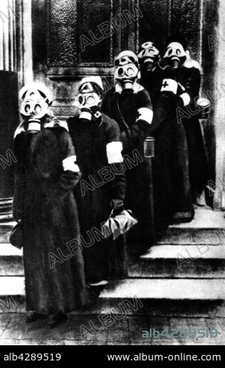 German ambulance women wearing gas masks, ready to leave to the front. 1917. Germany - World War I. Paris. Bibliothèque nationale.