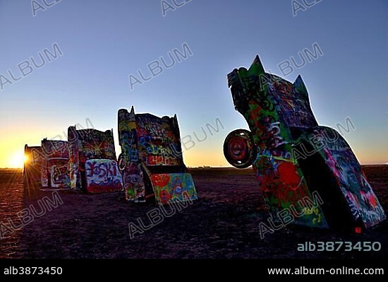 Sunset behind painted Cadillacs, public art installation Cadillac Ranch, artist Stanley Marsh 3, Route 66, Amarillo, Texas, USA, North America.
