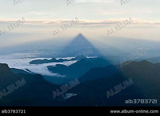 Pilgrim mountain, sun creating a triangle shadow in the landscape, image of God, Buddhist temple, Adam's Peak, Sri Pada, Dalhousie, Zentrales Hochland, Sri Lanka, Asia.