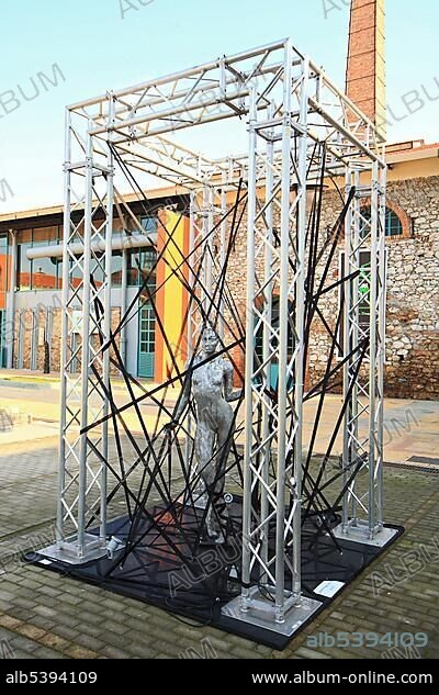 Free standing outdoor art installation, sculpture of a naked woman inside a metal scaffolding frame at the Gazi Factory in Athens, Greece, Europe.