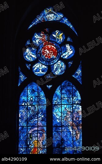 Marc Chagall. French school. Detail of the stained glass on the right side of the apse. Top: The attributes of Royalty . On the rose window: Symbol of Pascal lamb (Agnus Dei) surrounded by the symbols of the four Evangelists. Left lancet: The parable of the Good Samaritan . Right lancet: Parable of the Kingdom of God. Notre-Dame Cathedral, Reims . Marc Chagall (1887-1985). . The collection of stained glass windows painted by Marc Chagall at the Notre-Dame Cathedral in Reims, was created by the master glassworker Charles Marcq and the Atelier of Simon Marcq.. These photographic works are protected by legislation concerning literary and artistic property in all countries. Royalties are handled by ADAGP. To publish or diffuse these photographs, you must imperatively obtain the authorization of ADAGP or its correspondents abroad and to pay corresponding royalties. If you download this image in high definition, your postal address, telephone number and e-mail address will automatically be forwarded to ADAGP.. ADAGP - 11,rue Berryer - Paris. Tel. : (33) 1 43 59 09 79. Fax : (33) 1 45 63 44 89. E-mail : adagp@adagp.fr. Web : http://www.adagp.fr.