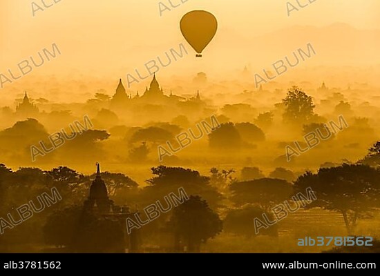 Hot air balloon over the landscape in the early morning fog, temples, stupas, pagodas, temple complex, Plateau of Bagan, Mandalay Division, Burma or Myanmar.