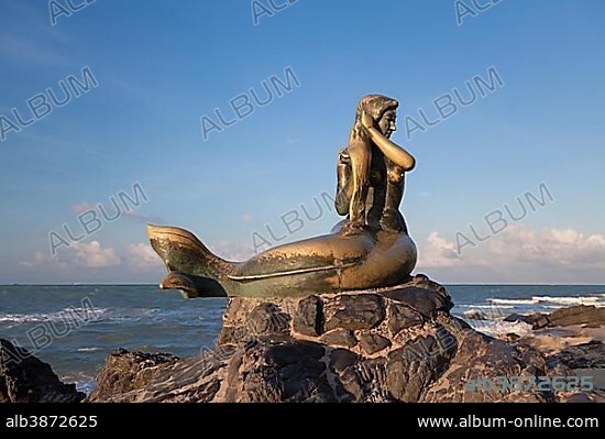 Golden mermaid statue on Samila beach, evening light, Songkhla, Thailand, Asia.