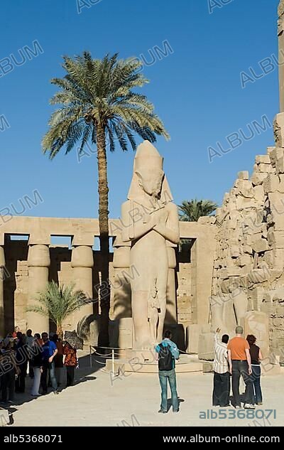 Statue of Ramses II with his daughter, Princess Bint-Anta between his legs, Great Court, Temples of Karnak, Luxor, Nile Valley, Egypt, Africa.